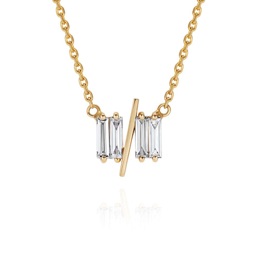 Close up of 11/11 necklace in yellow gold – featuring a thin yellow gold chain, and pendant featuring 4 long thin diamonds, with a thin diagonal gold bar, to look like the ‘11/11’ symbol.