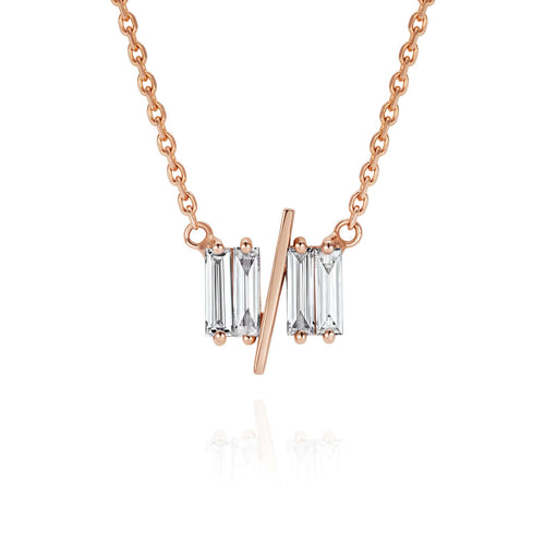Close up of 11/11 necklace in rose gold - featuring a thin rose gold chain, 4 long thin diamonds, with a thin diagonal gold bar, to make the ‘11/11’ symbol.