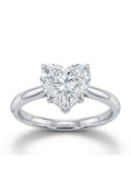Heart-shaped diamond ring on a white background