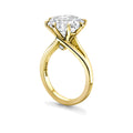 Gold ring with a large diamond on a white background