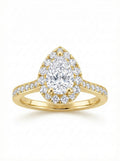 Gold ring with a pear-shaped diamond surrounded by smaller diamonds on a white background.